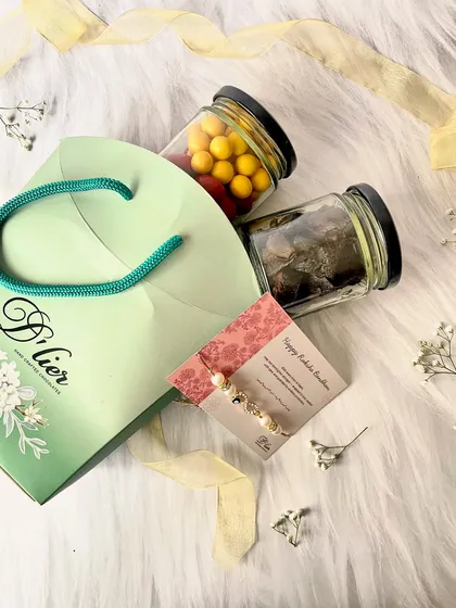 The complete Little Luxe Rakhi Hamper, including jars of sweet treats and a beautiful Rakhi, all packed in our signature D'lier gift bag.