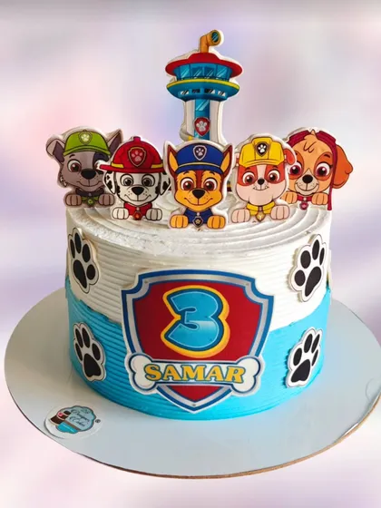 A classic Paw Patrol cake for a 3rd birthday. The design features the lookout tower and the main characters, ready for action on a combed whipped cream base.