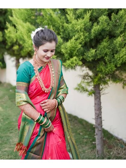 A wider portrait from an outdoor ethnic wear shoot. The natural setting complements the traditional pink and green saree, showing how I use environments to enhance the shot.