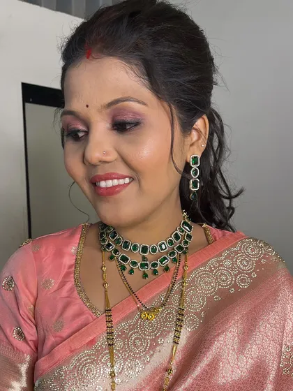 A close-up of the reception makeup, featuring shimmery pink eyeshadow and a matching lip color for a cohesive, elegant look.