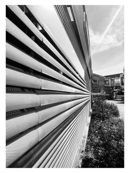 A throwback to an office campus we designed in 2010. The facade uses perforated metal screens to create a layered and textured appearance, which has matured gracefully over the years.