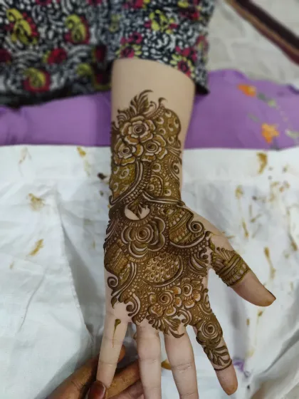 A single hand adorned with a beautiful floral pattern. This is a great option if you want something elegant and detailed without the commitment of a full-arm design.