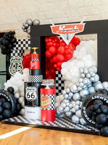 I bring high-octane fun with themes like Disney's Cars. This setup features a bold color scheme, a checkered floor, and iconic elements like the Route 66 sign and Rust-eze branding, creating a perfect racetrack atmosphere for any car enthusiast's birthday party.