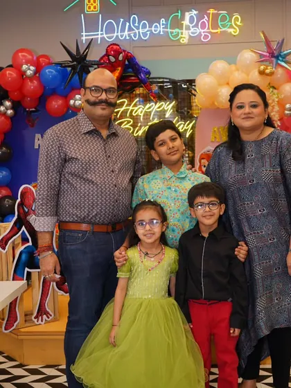 A perfect family portrait against a vibrant, superhero-themed backdrop. My goal is to create beautiful settings that result in cherished family photos and memories of your child's special day.