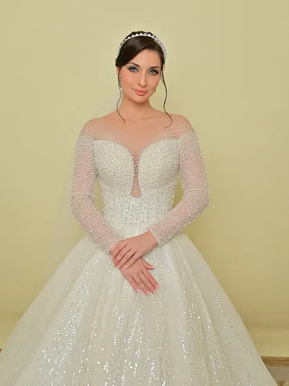 A full-length view of the bride in her sparkling white gown, a perfect vision of bridal elegance.