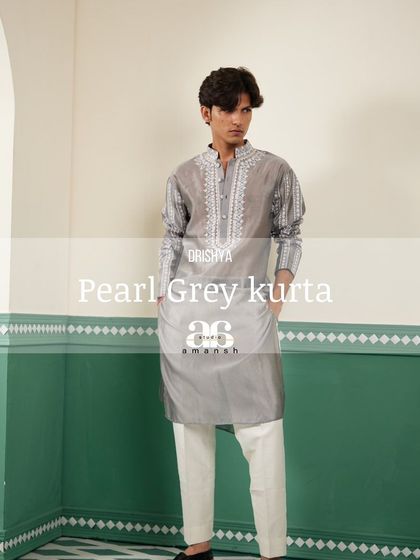 A stylized full-length shot of the pearl grey kurta, a piece of subtle and sophisticated festive wear.