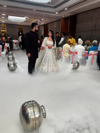 A wide shot of the couple's grand entrance, walking on a cloud of dry ice. This special effect adds a touch of fairytale magic to any engagement or reception.