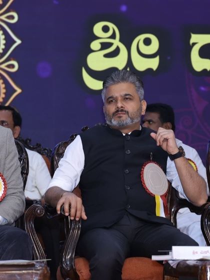 A candid moment on the dais during the Siddharameshwara Jayanti celebrations.