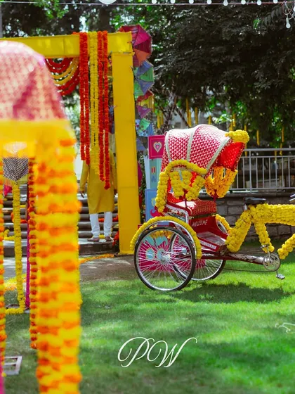 A marigold-decorated rickshaw, a perfect prop for a fun, desi-themed Haldi or Mehendi event.