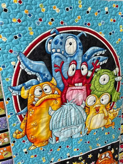 A close-up of the friendly monsters at the center of the quilt.