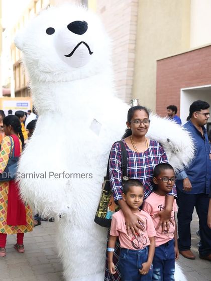 Our giant Polar Bear mascot poses with a family, creating a wonderful photo memory. This character is great for winter wonderland themes or any animal-lovers' party.