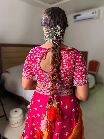 A closer look at the colorful Mehendi braid, showing the detail of the woven threads and the multi-colored tassels at the end.