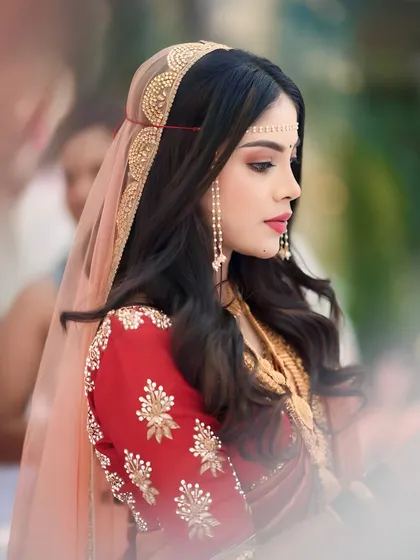 A beautiful side profile of the bride, highlighting her elegant headpiece and soft, romantic makeup.