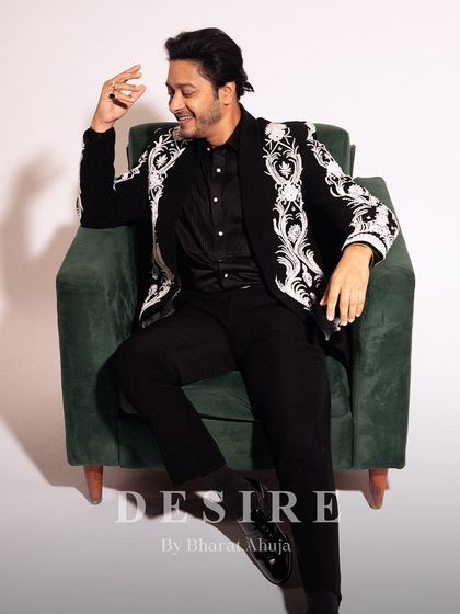 A moment of relaxed confidence. Shreyas Talpade wears my bespoke ceremonial jacket, a piece that is as comfortable as it is commanding. The intricate embroidery adds a layer of luxury to the classic black ensemble.