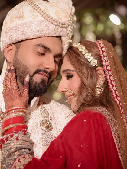 An intimate close-up capturing the bride's gentle touch and the couple's deep connection. The focus is on the emotion shared between them, a hallmark of my candid wedding photography style.