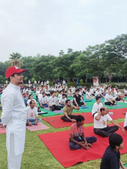 Me addressing the large gathering at our park yoga session, sharing the principles of yoga and wellness.