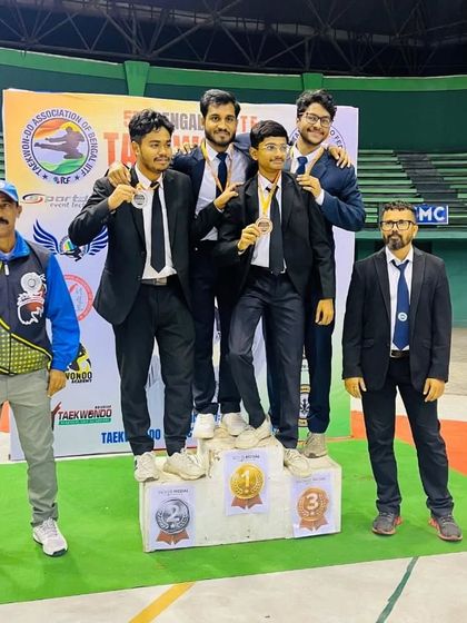 Our male athletes celebrating their wins at the Bengal State Championship, dressed formally for the awards ceremony.