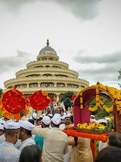 The Ashadhi Ekadashi Sobha Yatra is a vibrant procession of devotion. Our community carries the palki (palanquin) through the ashram grounds, with the Visalakshi Mantap in the background, creating a sea of joyful prayer and celebration.
