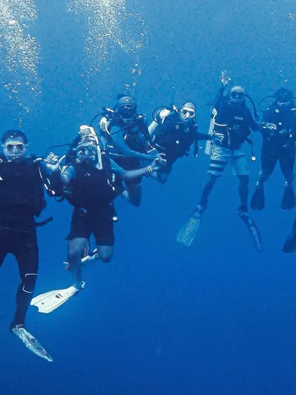 This is what it's all about. A group of divers, our new friends, exploring the incredible blue of Lakshadweep together. The camaraderie we build underwater is just as important as the marine life we see. This is our dive tribe.