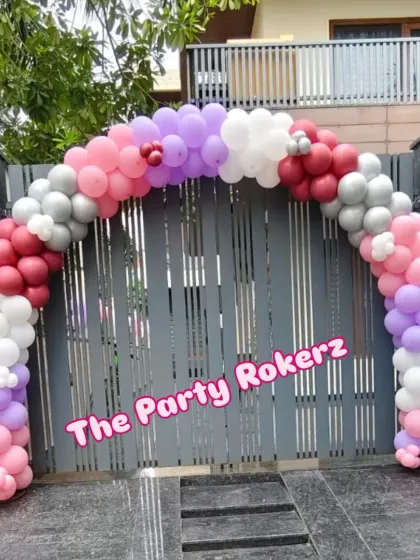 A welcoming balloon arch at the main gate sets the party mood right from the start. I used a mix of pink, purple, red, and silver to match the indoor butterfly theme.