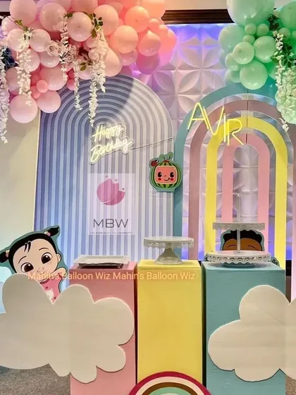 A pastel Cocomelon first birthday with modern, arched backdrops. The soft color palette offers a unique and stylish take on the popular theme.