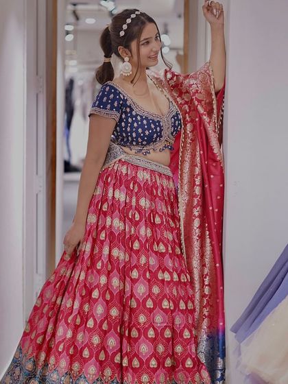 Unleash your inner diva in this dazzling vibrant lehenga. The combination of a pink skirt and a royal blue blouse is sure to turn heads.