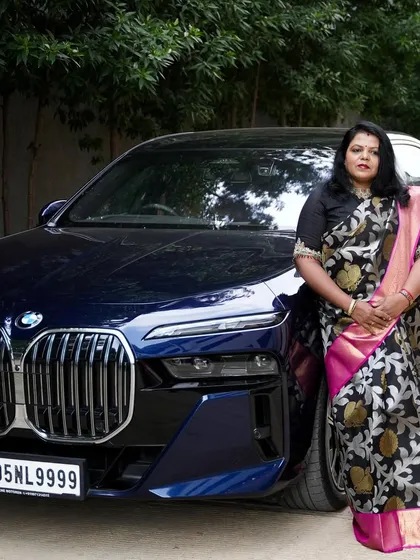Our client Girija Shivakumar looks powerful and elegant in a designer silk saree with a pink and black floral brocade.