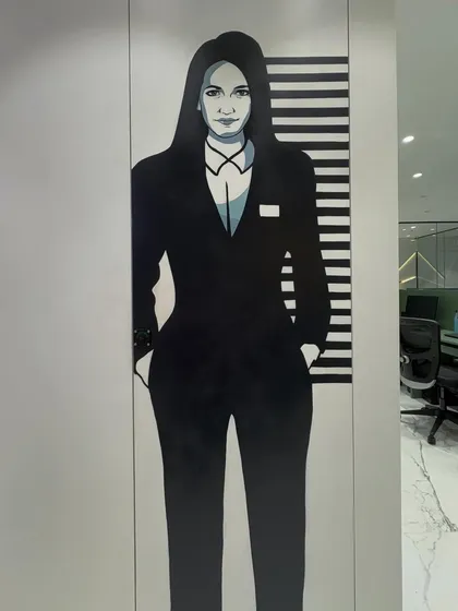 A close-up of the ladies' washroom mural, showcasing the sharp, graphic style of the full-height illustration.