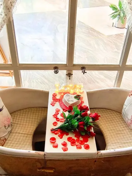 This is our unique bathtub dining spot, decorated for a romantic occasion with roses, petals, and a heart-shaped cake. It’s an example of how I can personalize any corner of the cafe for you.