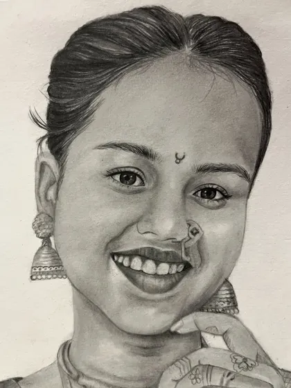A close-up of a realistic portrait, showcasing the fine details I can achieve with pencil. Notice the delicate shading on the jhumka earrings, the nose ring, and the subtle expression in her smile.
