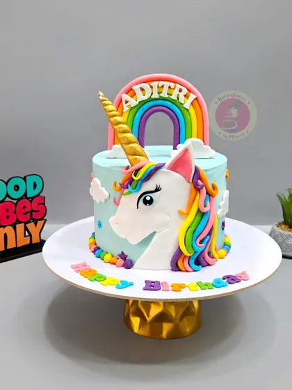 A magical unicorn cake with a rainbow mane and a golden horn. This is one of my most requested designs for little girls.