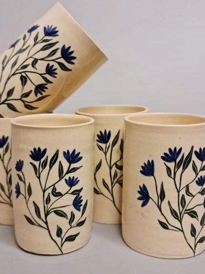 Discover the beauty of my handcrafted and hand-painted ceramic tumblers, featuring a delicate blue floral design. Each tumbler is lovingly crafted, ensuring a unique addition to your collection.