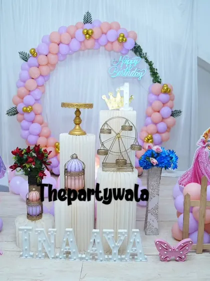 This Princess Sofia theme uses her signature purple color for the balloons and a life-size cutout. The setup is framed by a cute wooden fence and includes light-up letters for the name.