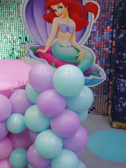 A close-up of the Ariel cutout and balloon decor. We use high-quality character standees to bring your child's favorite stories to life.