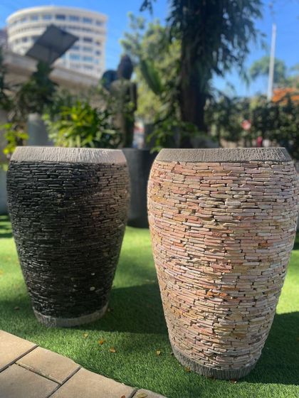 A pair of my statement pebble planters, one in black and one in a multi-toned brown, showcasing different color options.