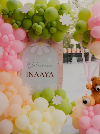 A cute welcome sign and teddy bear prop from Inaaya's half-birthday, showing the adorable details of the theme.