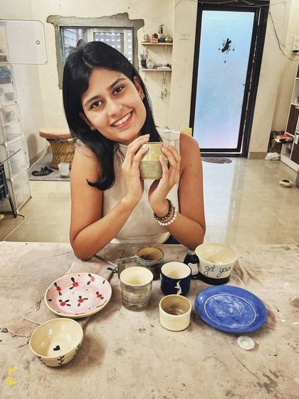After completing the intense potter's wheel course, this student created a beautiful collection of mugs and plates with delicate, hand-painted floral and fruit motifs.