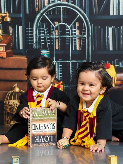Two future wizards, one book of spells. This twin photoshoot captures a sweet moment of shared discovery in our Harry Potter themed studio.