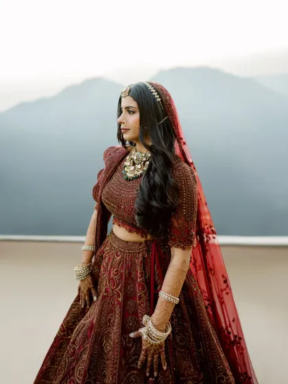 A bride stands against the vastness of the mountains, wrapped in tradition and her own quiet strength. This portrait is about more than just the beautiful lehenga; it's about capturing the emotion, the anticipation, and the timeless elegance of a woman on the cusp of a new beginning.