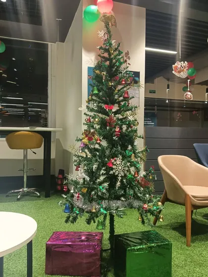 Here is another Christmas tree we decorated for a corporate lounge area. We used a variety of colourful ornaments and placed wrapped gift boxes at the base to complete the festive look.