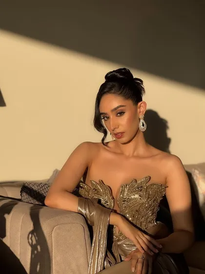 Capturing the magic of golden hour for a cocktail glam look. This full-shot highlights how the makeup, with its warm tones and radiant finish, works with the lighting and the metallic sheen of the gown. It's a sophisticated, editorial style perfect for an elegant evening event.