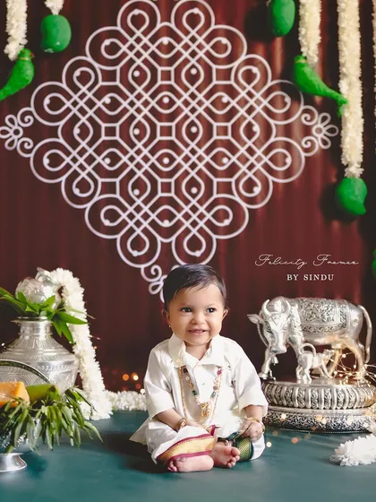 A happy smile for the festival of Ugadi. This little one is surrounded by traditional elements, celebrating new beginnings.