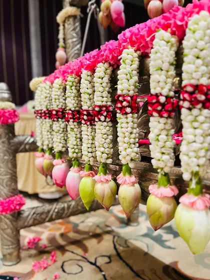 The details are what make a decoration truly special. This close-up shows the delicate craftsmanship of jasmine, rose, and lotus bud garlands I create by hand to adorn a naming ceremony cradle, ensuring every element is perfect.