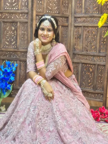 A lovely pastel pink lehenga with all-over floral embroidery. This is a great choice for a spring wedding or a Mehendi function.
