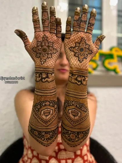 A client showing her beautiful, symmetrical mehndi designs, ideal for any festive occasion.