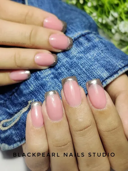 A chic and glamorous look featuring silver chrome French tips. This design offers a modern, metallic twist on the classic French manicure, perfect for a sleek and stylish statement.
