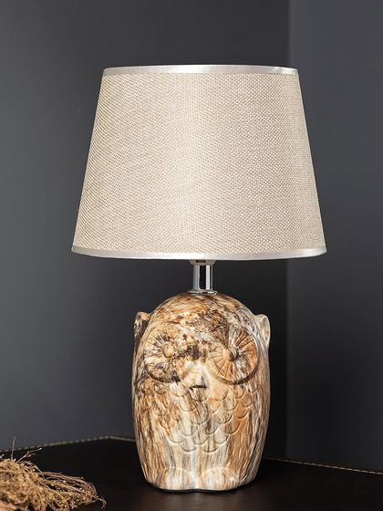 This Owl Wisdom lamp adds a touch of whimsy and character to a room. The ceramic base has a rustic, stone-like texture, and the neutral-colored shade makes it easy to place in any study or living room.