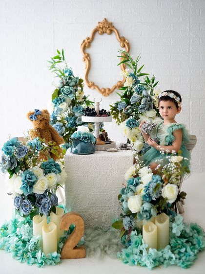 A sophisticated tea party for a second birthday, with a beautiful color palette of dusty blue and sage green.