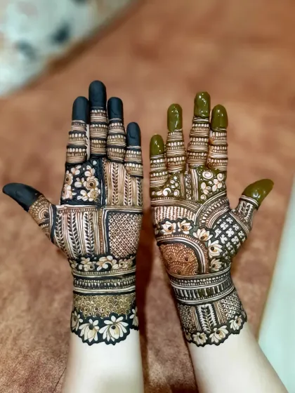 A beautiful bridal design with different patterns on each hand. One features leafy vines while the other has checkered blocks and floral motifs.