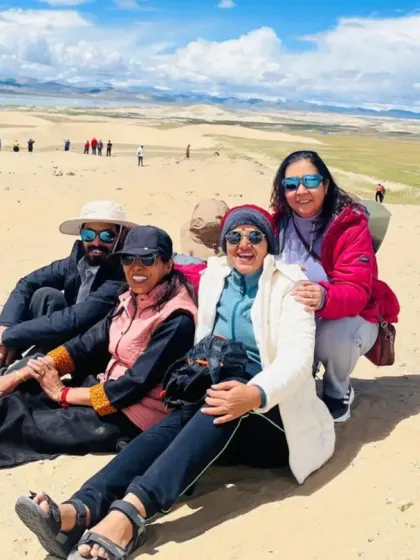 Resting together in the surprising landscape of Tibetan sand dunes. The journey is as much about the bonds we form as it is about the destinations we visit.